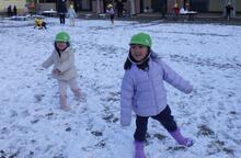 長靴で雪の上に立つこどもたちのようす